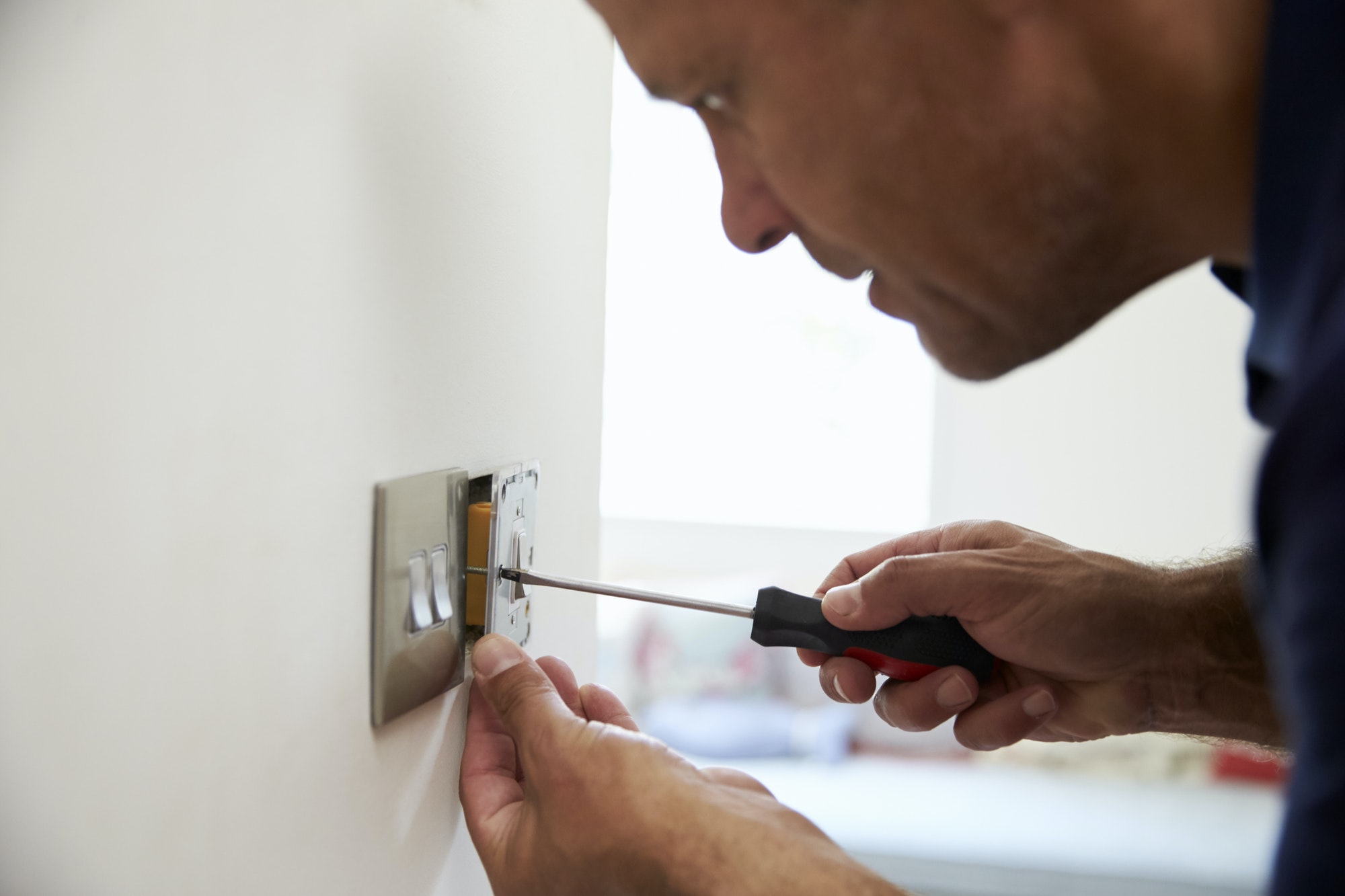 Electrician Repairing Domestic Light Switch